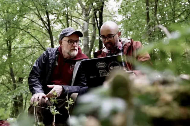 Two persons in the forest.