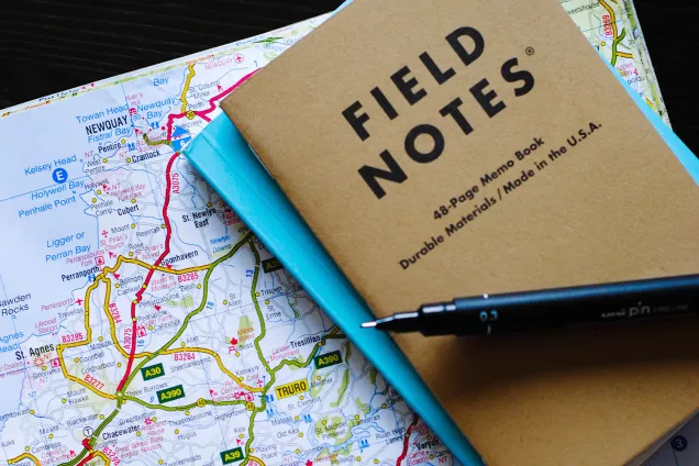 Notebooks on a map. Photo.