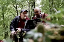 Two persons in the forest.